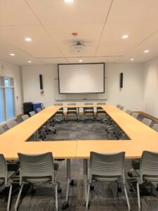 Room 101 with a full rectangle shape of tables.
