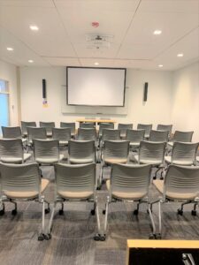 Room 101 features a screen, speakers, and multiple chairs.