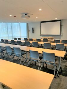 Room 104 with rows of tables.