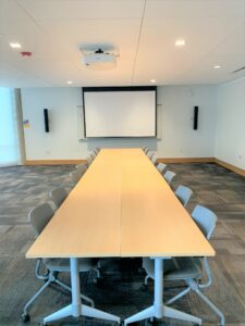 Room 104 with a large conference table.