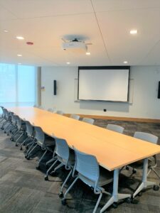 Room 104 with a large conference table.