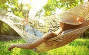 Someone laying in a hammock in the sun